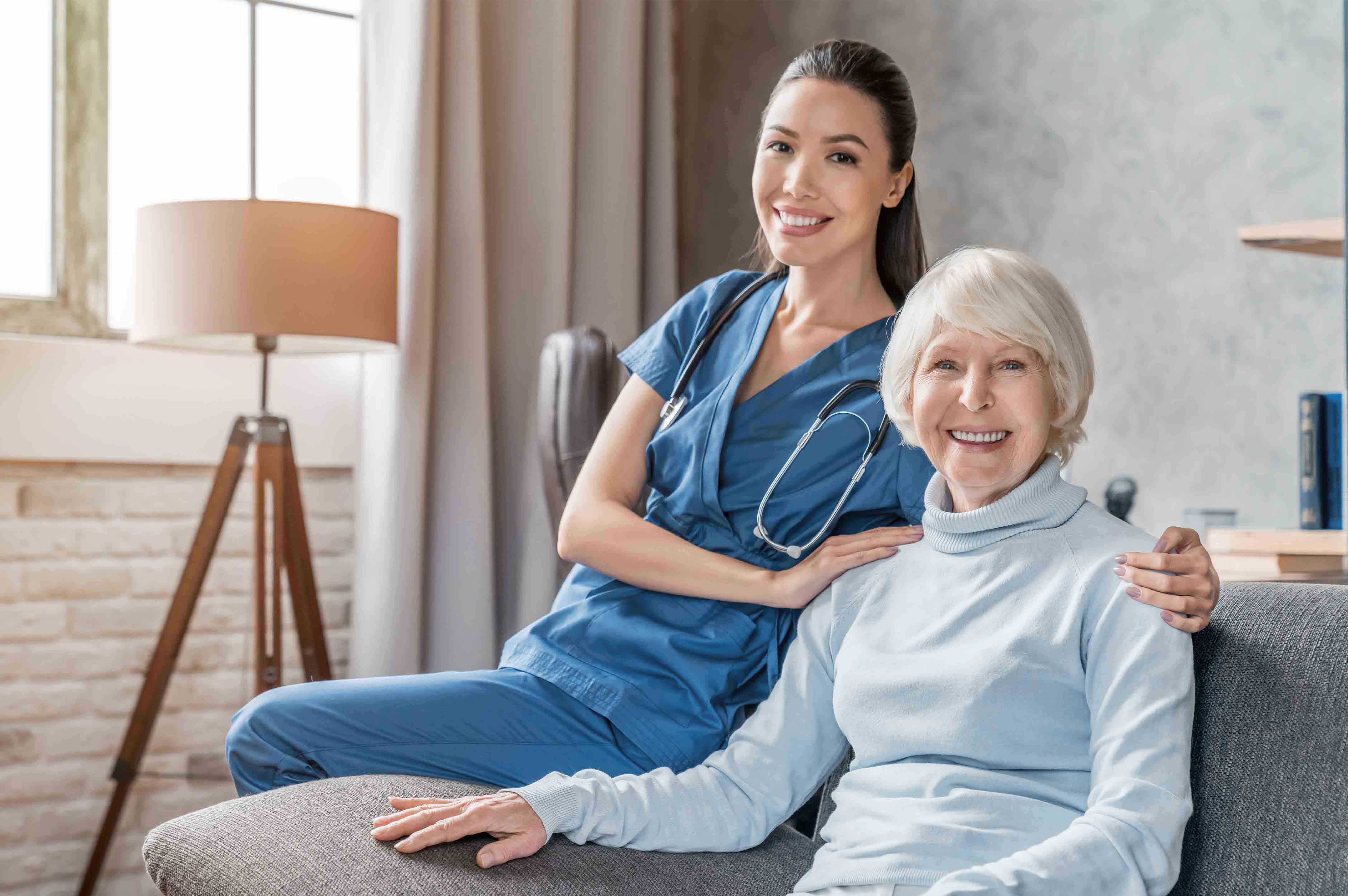A nurse with a happy senior client at home