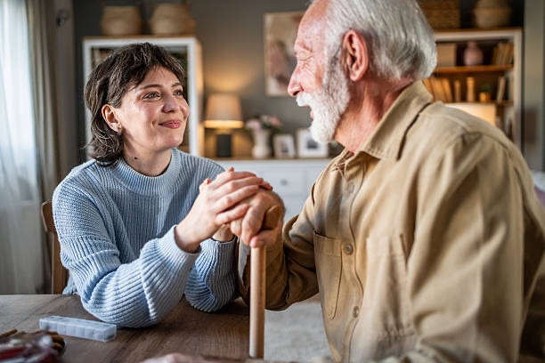 Equinoxe nurse holding the hand of an elderly client